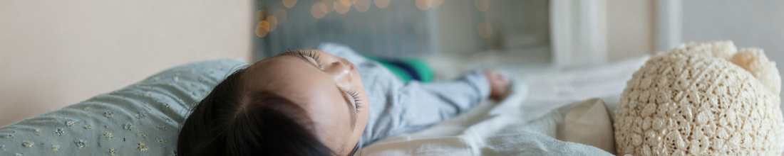 kid sleeping on bed