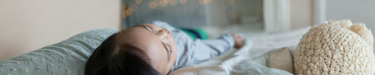kid sleeping on bed