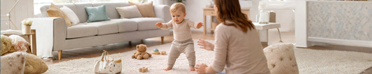 toddler learning to walk indoors with mom watching